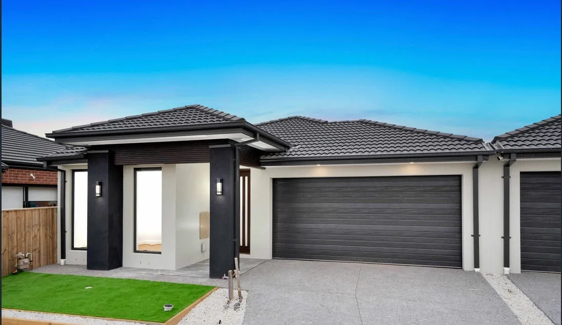 Concrete driveway leading to a modern home